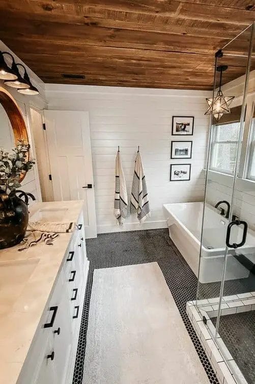 Photo of a modern bathroom farmhouse design with white walls and rustic wooden ceiling.
